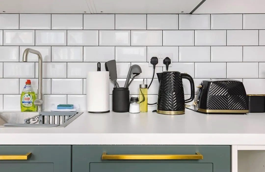 Kettle, toaster and utensils on a white worktop