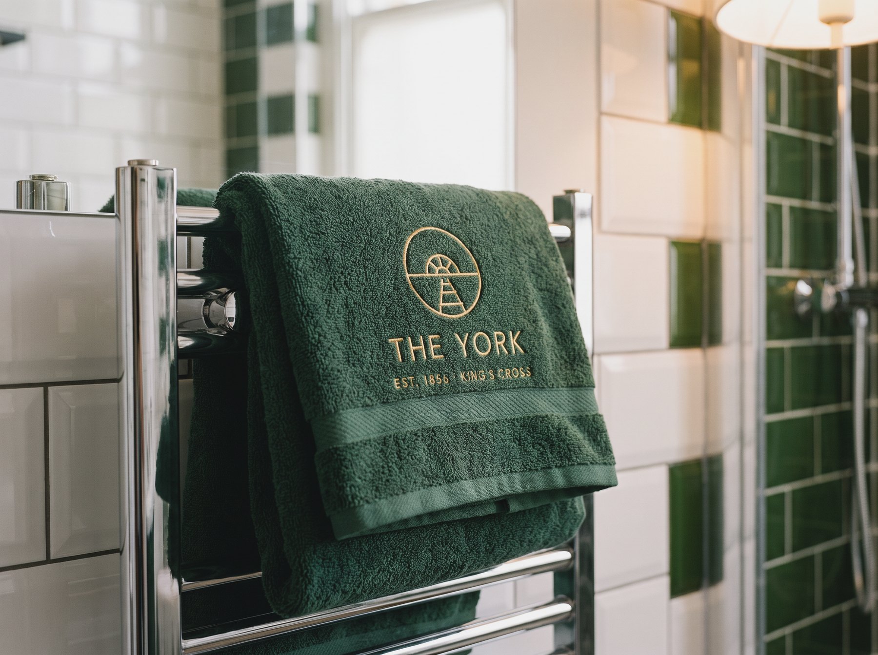 Towels embroidered with The York's mark, hanging on a rail